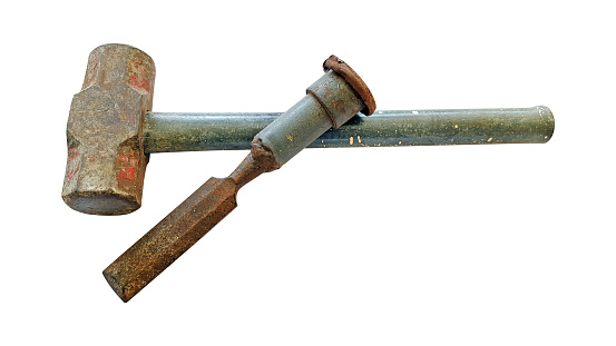 old rusty metal hammer with chisel on white background
