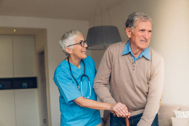 istock Happy nurse helping patient walk 1085697576