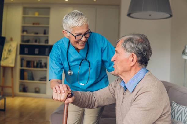 istock Man with a cane looking at the nurse 1085697696