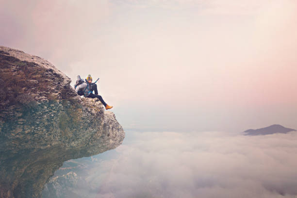 Young hiker man over the clouds.