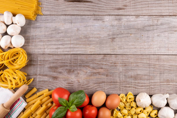 istock pasta, vegetables, eggs, on wooden board, ingredients for Italian restaurant 1085698104