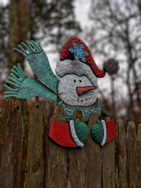 istock Holiday decorations snowman on a fence 1085707766