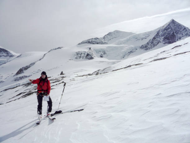 istock male backcountry skier using a map on a high alpine glacier in the Austrian Alps and pointing to the right direction 1085710342