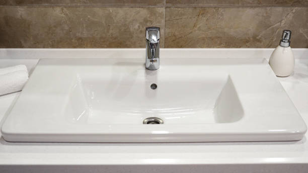 istock a silver tap in a white bathroom 1085713242