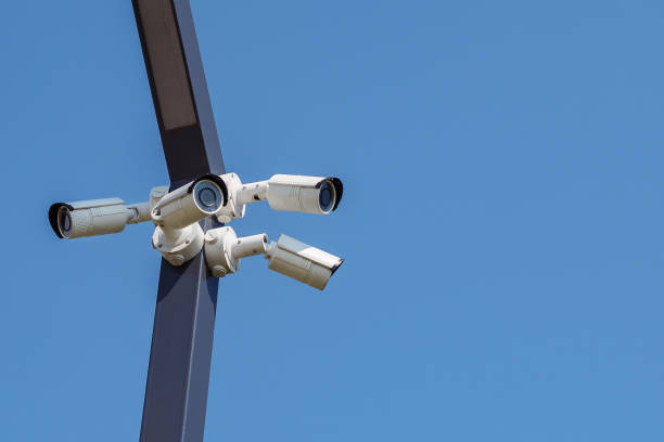 istock Multi-angle CCTV surveillance security camera video equipment on the blue sky background 1085713342