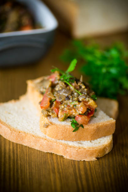 istock eggplant caviar with tomatoes and a slice of bread 1085713540