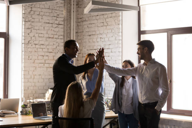 istock Friendly successful multi-ethnic business team giving high five together 1085713944