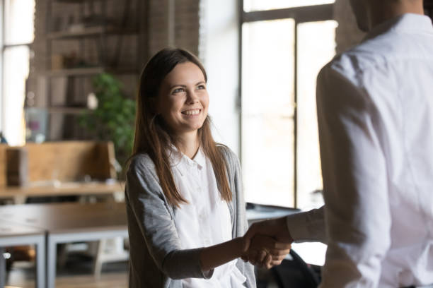 istock Excited girl intern handshaking executive manager getting hired rewarded 1085714018