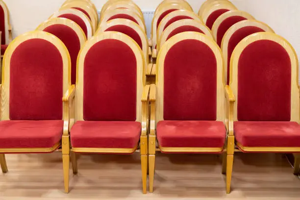 Photo of red chairs in an empty concert hall