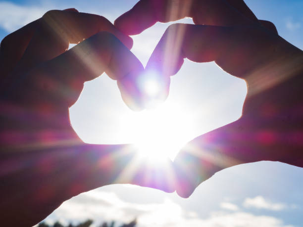 istock Boy hands form a heart against the sun beams. 1085726996