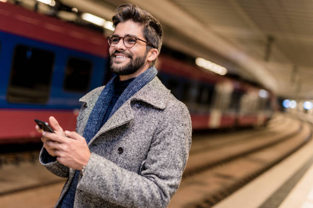 istock Happy young businessman waiting for a train. 1085729464