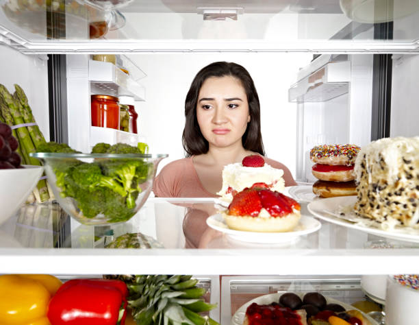 istock Woman looking into a fridge 1085729878