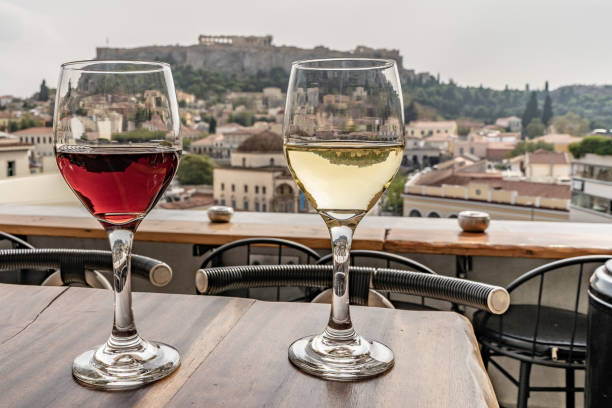 Wine glasses on a roof top in Athens, Greece. View of the Acropolis. stock photo