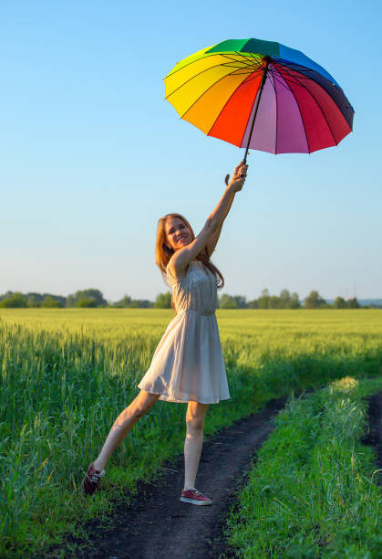 istock girl with a multicolored umbrella 1085735938