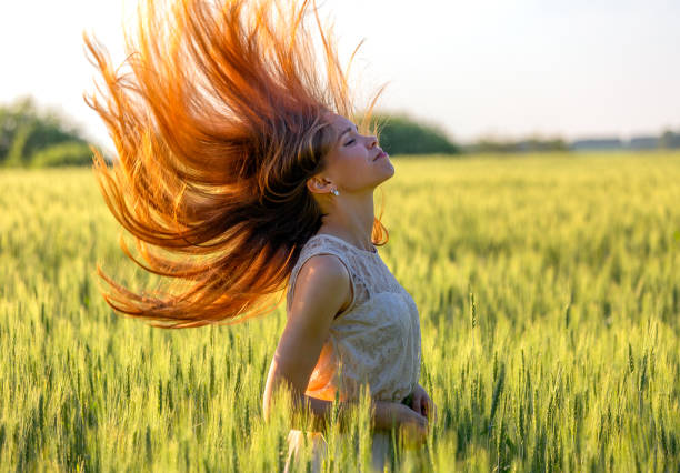 istock girl with blowing red hair 1085735956