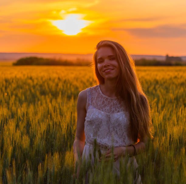 istock Pretty girl in field at sunset 1085736026