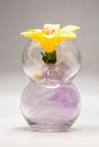 istock Bunch of Artificial Decorative Flowers on Transparent Vase On Table 1085738078