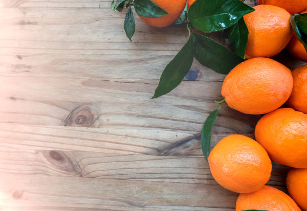 istock Oranges with leaves  on a wooden table. Top view with copy space 1085745330