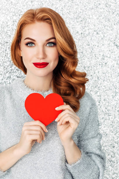 istock Beautiful woman cardboard heart 1085750878
