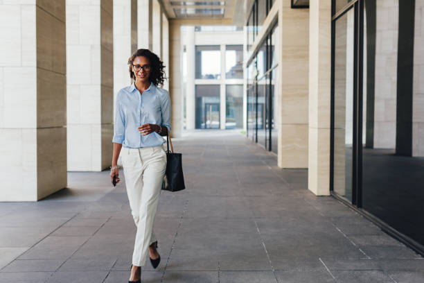 istock Woman walking from office with bag bag on her hand 1085756994