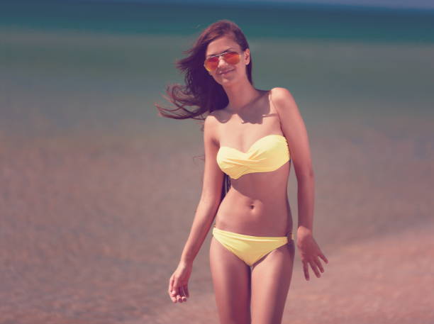 istock yellow bikini sea, close up 1085757048