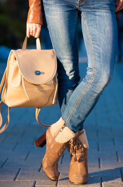 istock Woman legs boots and handbag backpack 1085760578
