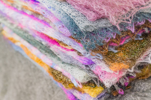 istock Stack of knitted downy scarfs . Russian famous Orenburg shawls. Crochet  pattern. 1085762168