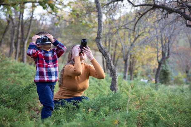 istock Mother and Son taking Photo in nature 1085766036