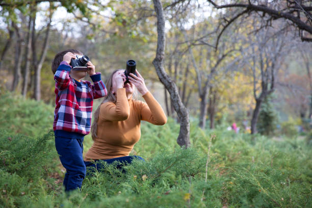 istock Mother and Son taking Photo in nature 1085767120