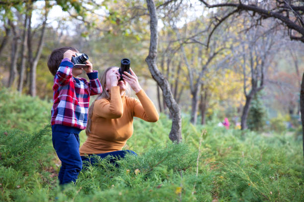 istock Mother and Son taking Photo in nature 1085767262
