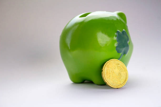 istock green piggy bank with coins 1085774184