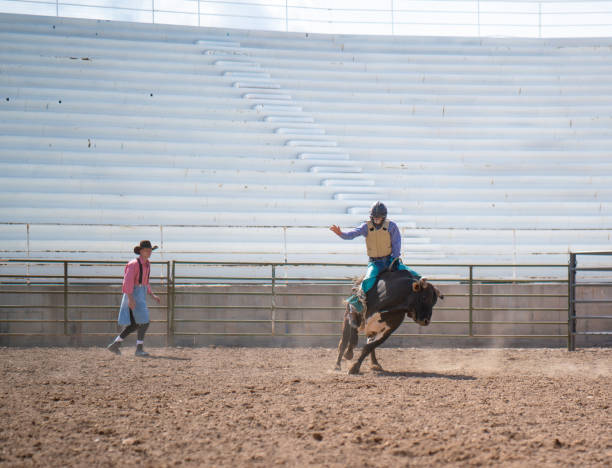 istock Cowboy Bull Riding in Rodeo Arena 1085776904
