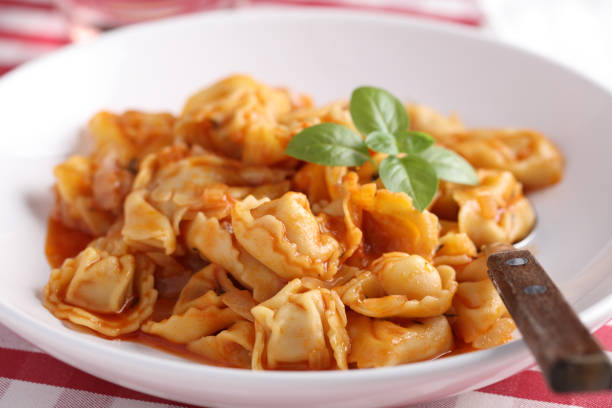 istock Ravioli dumplings under tomato sauce with basil leaf 1085778628