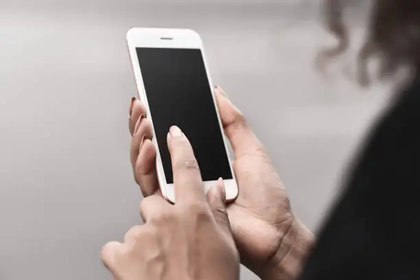 Photo of Close up hand of young mixed race business woman using phone contact with partner at outdoor, business people success in job, business co-working teamwork concept