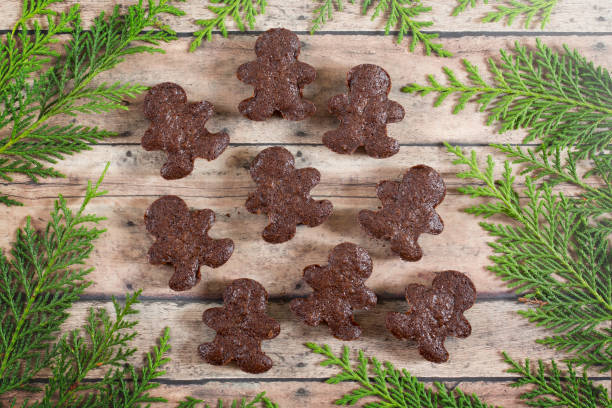 istock Gingerbread Man Shaped Brownies on a Wood Background with Greenery 1085790182