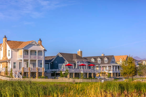 istock Homes with porch balcony and lawn under blue sky 1085790288