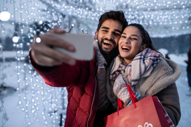 istock Young romantic couple taking Selfie while ice-skating 1085790430