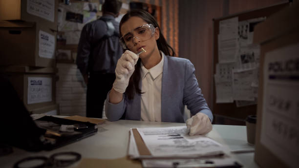 istock Forensic scientist lady examining the evidence bullet from the crime scene 1085793088