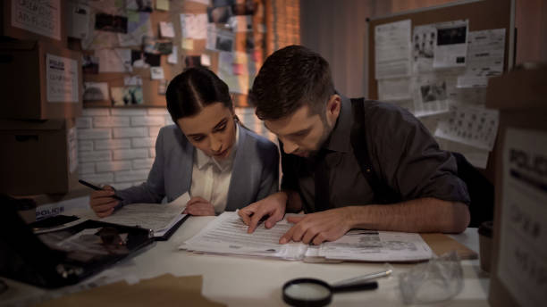 istock Two defense lawyers working overnight and finding answer in top secret files 1085793202