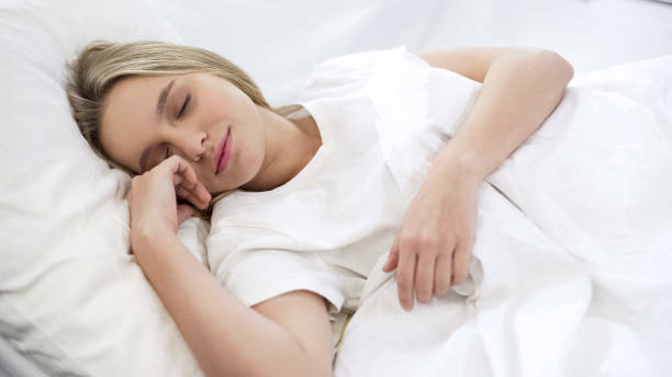 istock Satisfied woman sleeping in bed, relaxation time, resting after hard busy week 1085793268