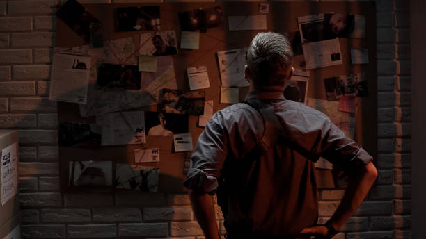 istock Policeman analyzing information of crime on investigation board, professional 1085793284