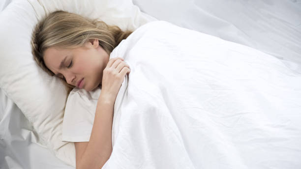 istock Capricious teenage girl refuses to wake up, pulling on blanket, lazy morning 1085793530