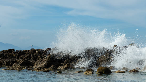 istock Rocks can't hold back the sea. 1085798858