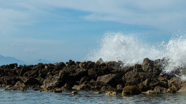 istock Ocean waves crash over rocks along the shore. 1085798872