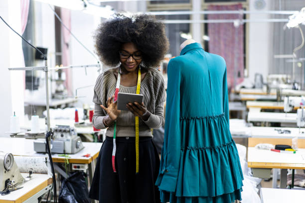 istock African woman using tablet in clothing design studio 1085803022