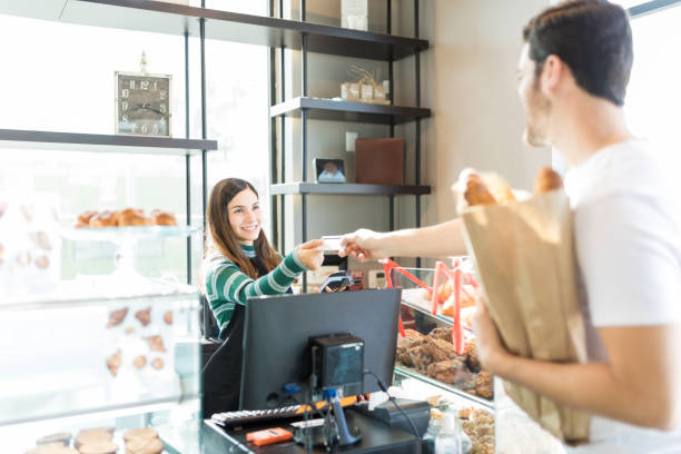 istock Bakery Owner Receiving Cashless Payment From Man 1085812828
