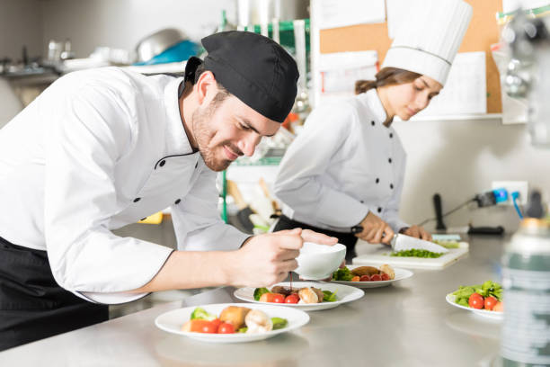 istock Chef Adding Flavors To Food In Kitchen 1085812986