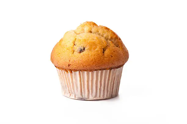 Photo of Muffin in paper baking cup isolated on white background