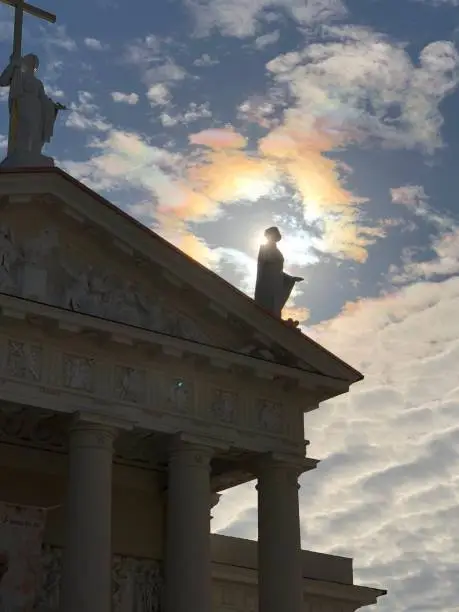 Sun behind the statue at Vilnius Cathedral