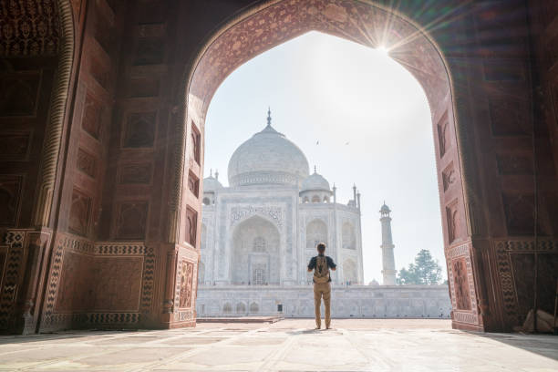 wonderlust man discovering beautiful taj mahal at sunrise - agra imagens e fotografias de stock